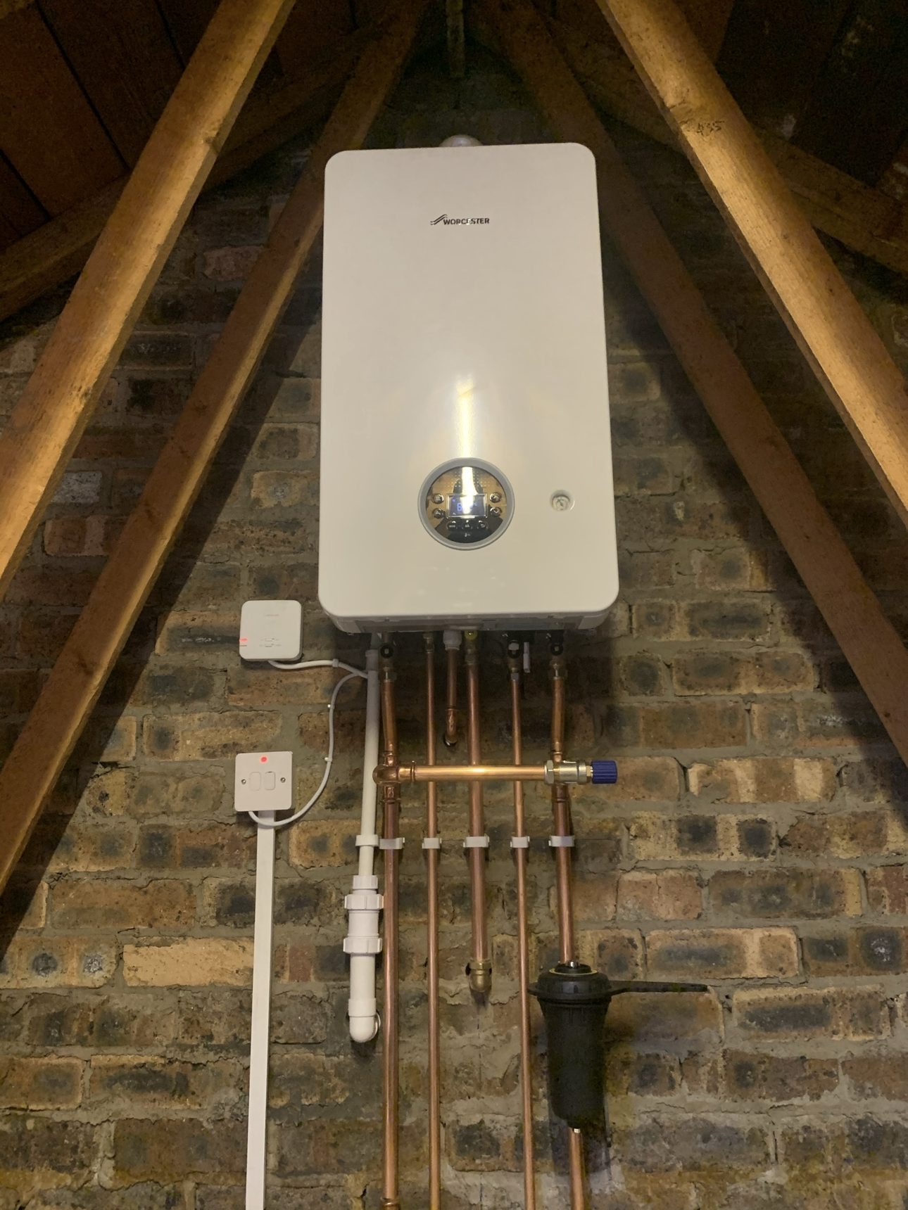 Wall-mounted Worcester combi boiler with copper pipework and isolation valves repaired in an Edinburgh home