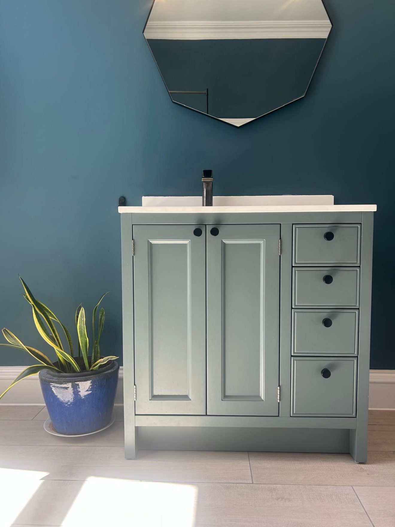 Sage green vanity unit with white basin top and hexagonal mirror fitted by Pentaburgh's in-house bathroom team in Edinburgh