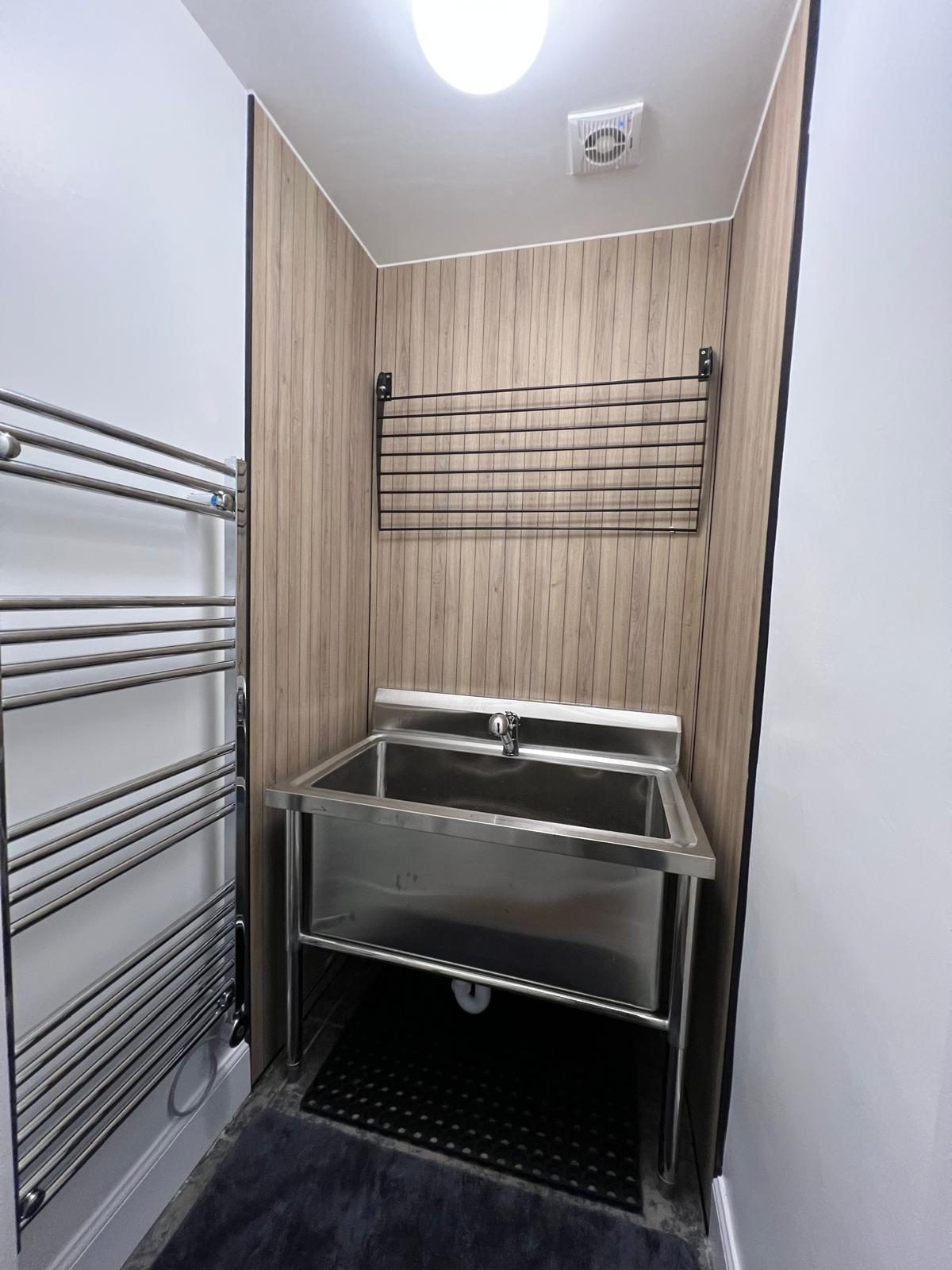 Large steel utility sink installed with new plumbing in a Loanhead property
