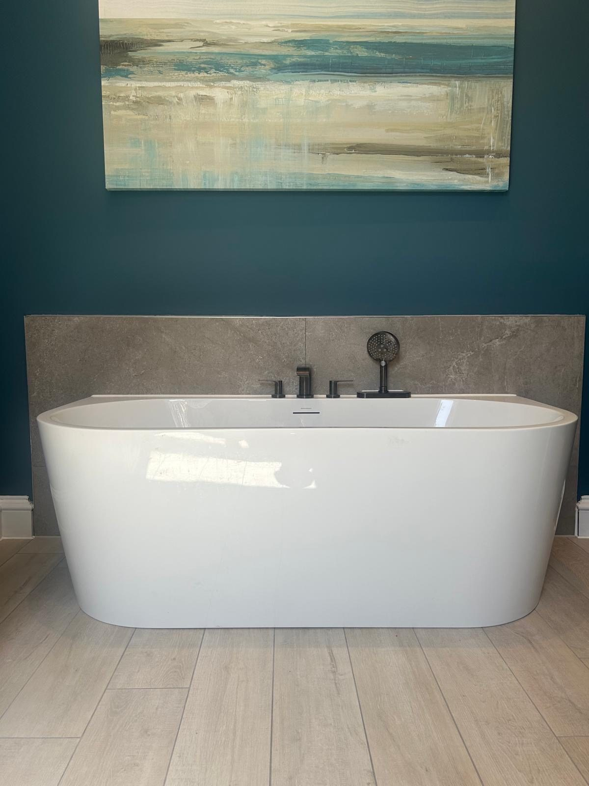 Freestanding bath with matt black taps and stone tiling fitted by Pentaburgh in an Edinburgh bathroom