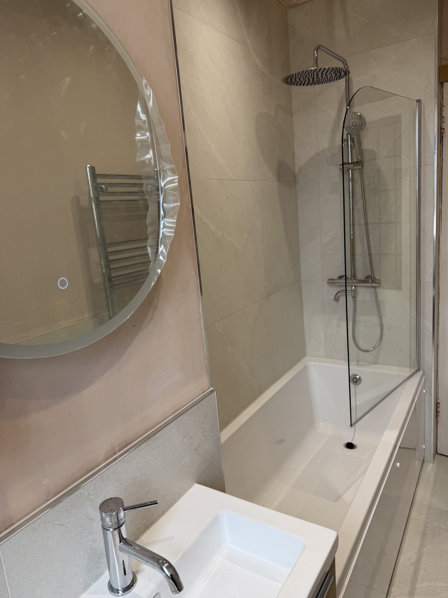 Over-bath shower with rainfall head and glass screen in an Edinburgh bathroom