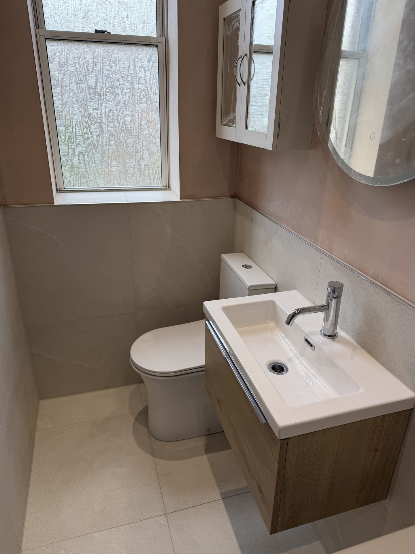 Compact modern bathroom with wood-grain vanity unit fitted in Bonnyrigg