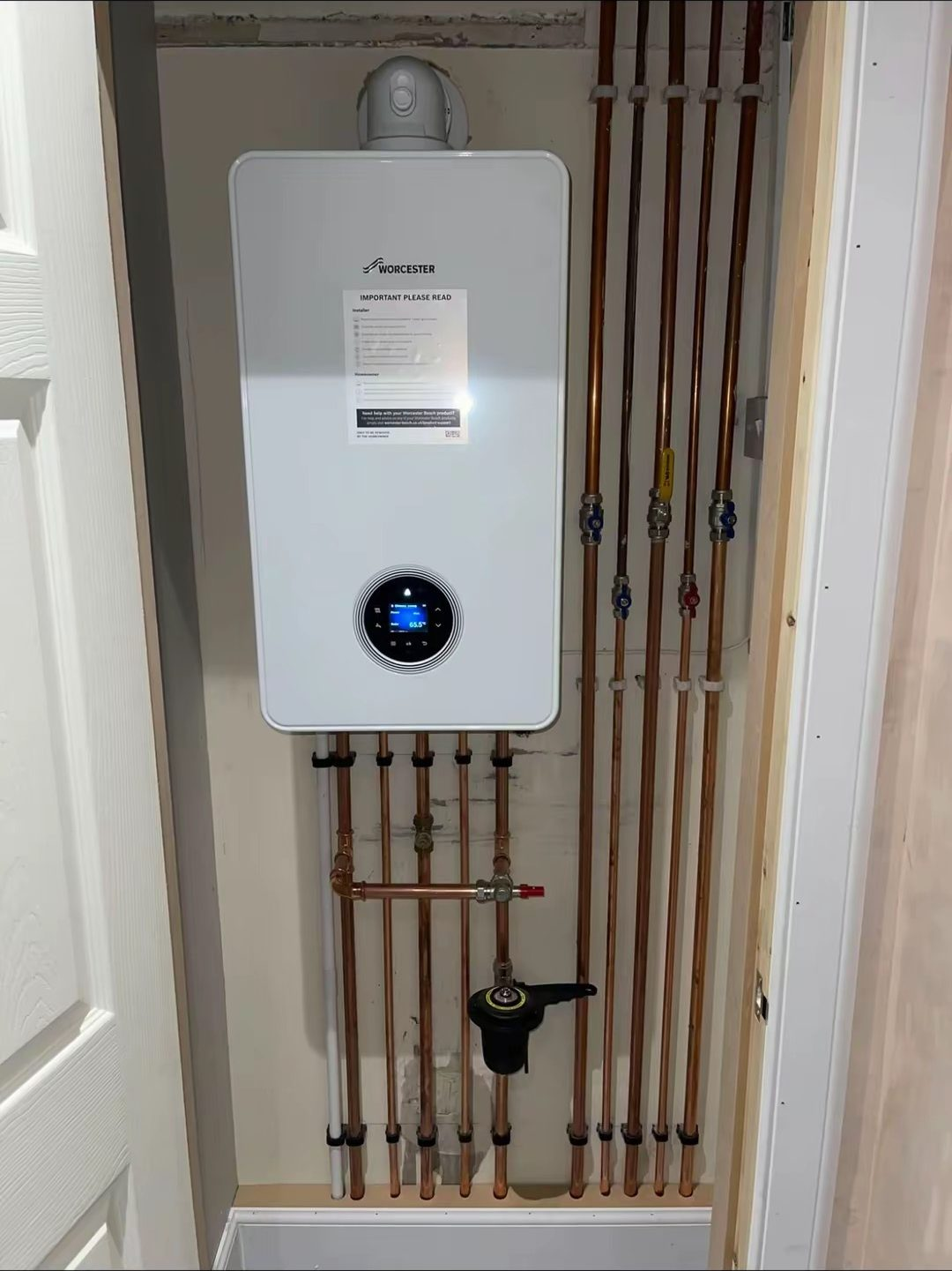 Central heating flow and return copper pipework neatly clipped in a riser cupboard by a Pentaburgh heating engineer in Edinburgh