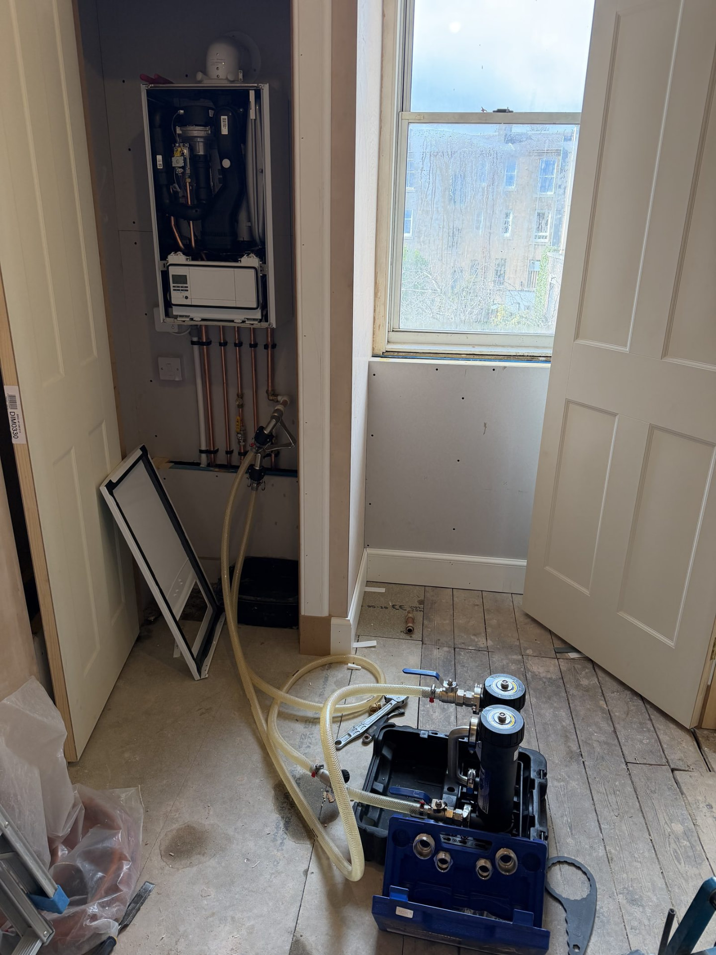 Flushing and filling pump connected to a boiler during heating system maintenance in Edinburgh