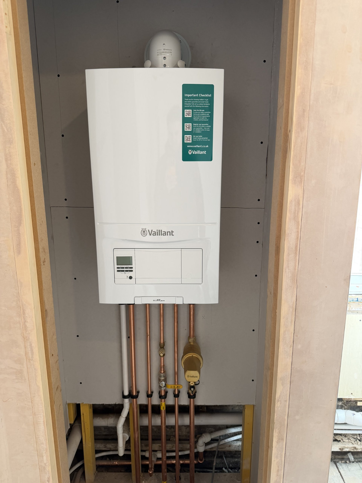 Newly installed wall-mounted Vaillant combi boiler with neat copper pipework in an Edinburgh property